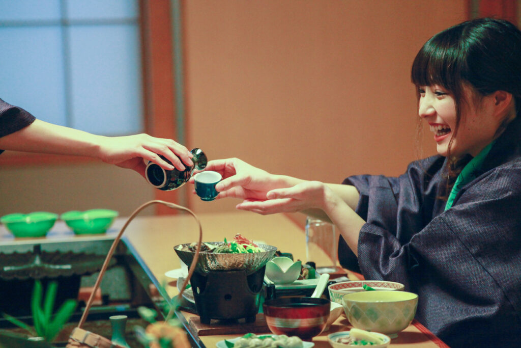 2 woman enjoy Japanese ryokan inn wearing yukata drinking sake nihonshu guide