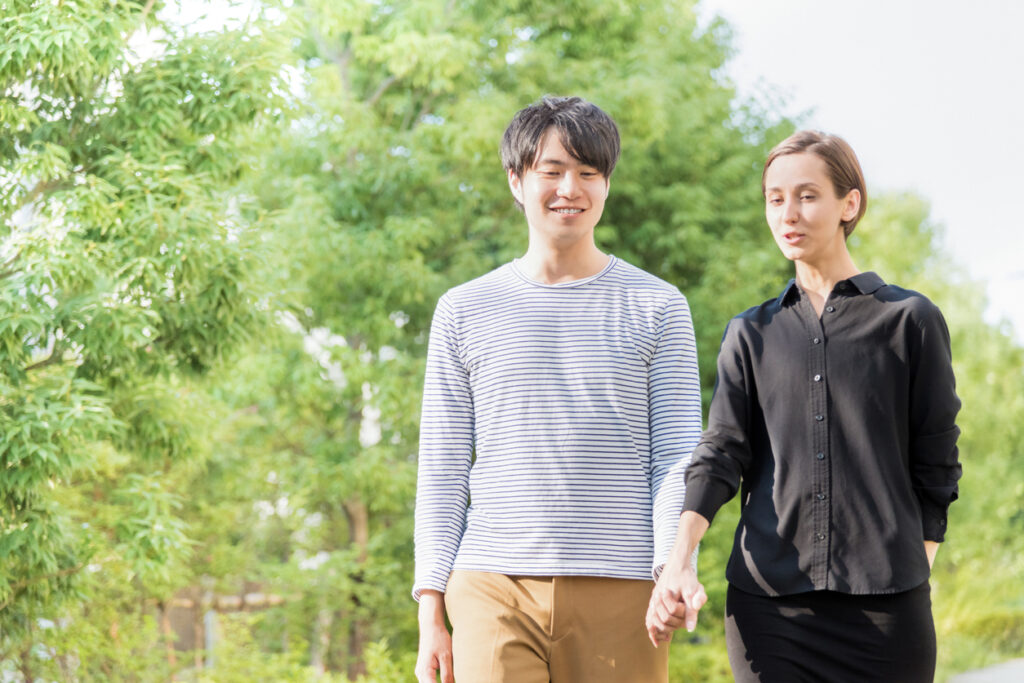 International couple walking (Western and Asians) image.