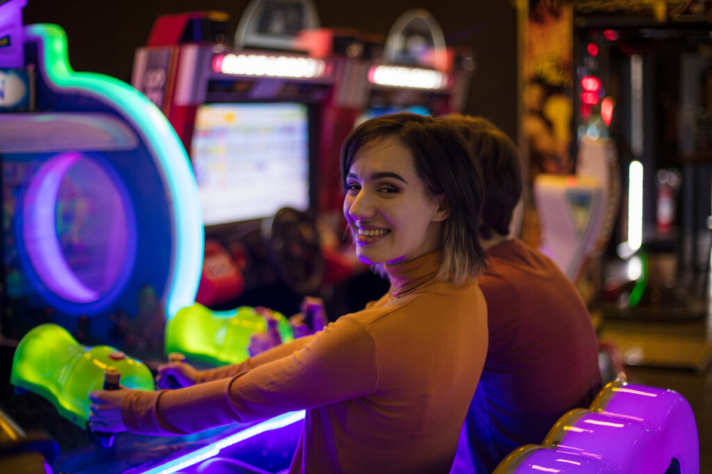 Couple having fun in playroom. Playing a games. Smiling woman looking at camera.