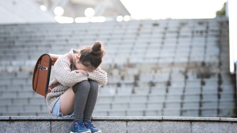Ijime: Bullying in Japanese Schools Elementary school students sitting on the steps and crying