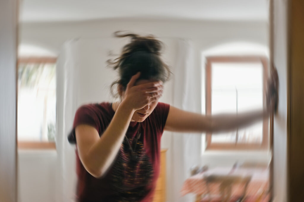 Woman suffering from vertigo or dizziness or other health problem of brain or inner ear.