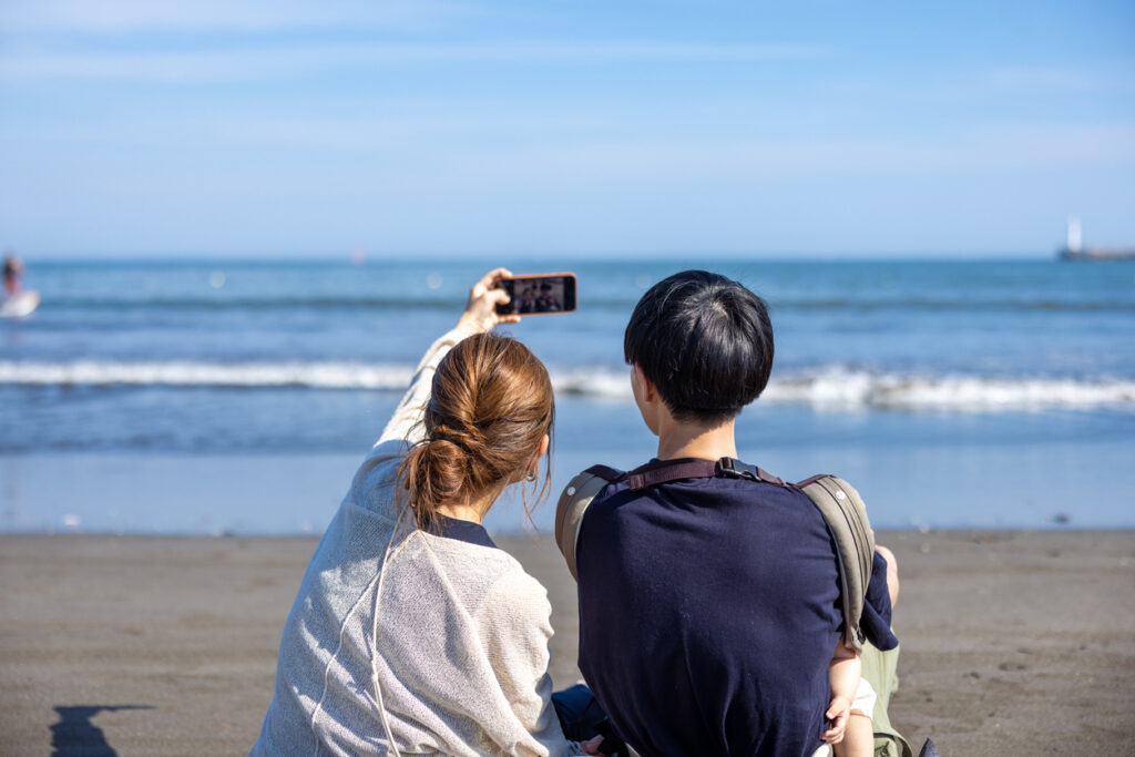 Family with one child enjoying vacation at travel location. Walking on shopping street and having happy time in guest house.